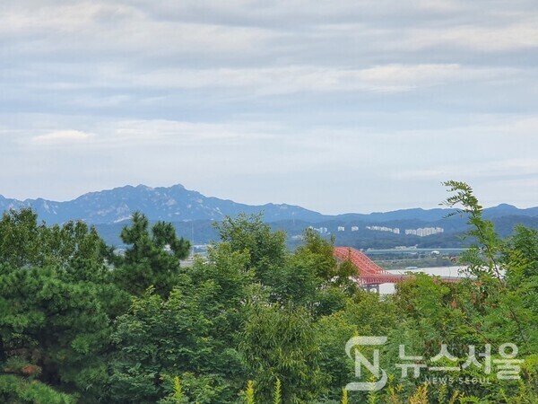 개화산 전망대에서 바라본 한강과 북한산. 강서둘레길 제1코스 가운데 ‘개화산 전망대’가 있다. ‘개화산 전망대’에서는 가까이 한강과 방화대교가 뚜렷이 보이며, 멀리 북한산의 모습도 보인다.